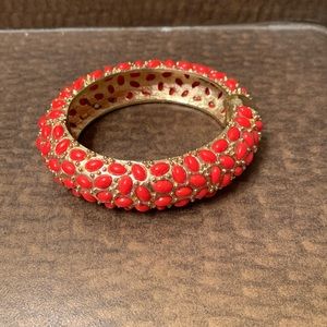 Magnetic clasp bangle bracelet - gold with coral colored stones.